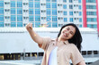 © M Alfan Setyawan - happy asian young woman holding sparklers celebrate new year eve in outdoor roof top with city building background