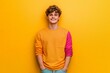 © authapol - Cheerful and Confident Person Standing Against a Bright Yellow Background with Hands at Their Sides, Showing a Joyful Expression and Playful Attire