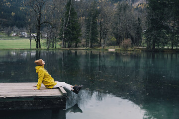 Wall Mural - Woman looking at mountain lake in Slovenia. Travel Europe.