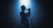 © Gorodenkoff - Portrait of a Handsome Young Man Singing a Song at a Music Contest. Cinematic Spotlight Creates a Silhouette Effect, His Charismatic Stage Presence and Lyrics Electrify the Stage