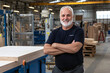 © Luluraschi - a carpenter in a woodworking shop for plywood production, showcasing the large stock of goods