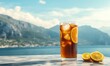 © Babycrab - A refreshing glass of iced tea with lemon slices, set against a scenic coastal backdrop.