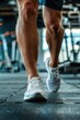© Fotograf - Close-up shot of a person's legs during exercise at the gym, ideal for fitness and wellness concepts