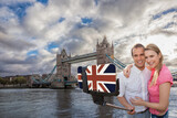 Fototapeta Big Ben - Couple in love taking a selfie portrait in front of Tower Bridge on their way around London, England, UK