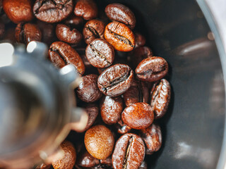 Close-up of roasted coffee beans in a coffee grinder