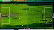 © Iryna - Aerial view of a soccer match on a bright green field. An aerial shot capturing a soccer match in action on a bright green turf field.