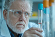 © JoeyMarut - A scientist in lab coat examines test tube with focused expression, showcasing dedication and precision required in scientific research