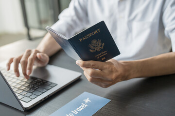 hand man online booking and buying plane tickets using laptop phone and credit card planning trip tr