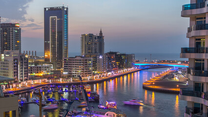 Wall Mural - An Aerial view of Dubai Marina towers in Dubai day to night timelapse