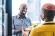 © BullRun - Cheerful black customer getting plate with cake from hand of barista