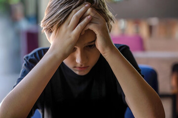 Sad child, stress and depression. Fear children hand cover face. Boy covering face with hands. Children's bullying, unhappy kid boy hands hides his face