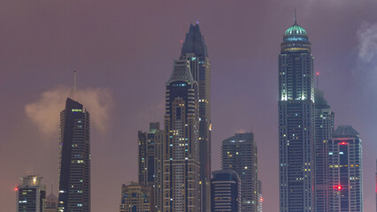 Wall Mural - Modern skyscrapers in Dubai city night to day timelapse from the Palm Jumeirah Island.