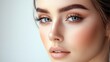 © Oleksandr - Stunning close-up of a young woman showcasing flawless skin and captivating blue eyes in soft, natural light indoors