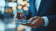 © Warakorn - Businessman analyzing financial data on digital tablet, modern office setting, professional atmosphere