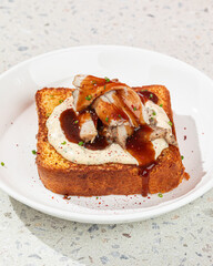 Wall Mural - Portion of brioche breakfast toast with turkey brisket and sauce