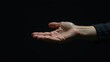 © Oxana39 - Open hand on dark background: gesture of giving or receiving