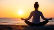 © Chanagun - A person meditating on the beach at sunset, embodying peace and tranquility.