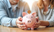 © Radorog. - an elderly couple throws coins into a piggy bank
