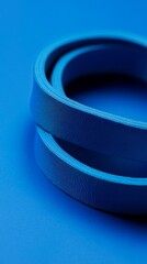 Poster - Two grosgrain ribbons forming concentric circles on a blue background create an interesting abstract composition, perfect for backgrounds and design projects