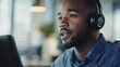 © WS Studio 1985 - Confident man wearing headset engaged in conversation while working at modern office, promoting effective communication and professionalism in the workplace environment