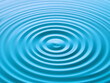 © Vectplus - Rippling blue water surface creating circular patterns in a tranquil setting with soft light and reflections
