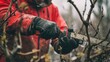 © orendesain99 - Man Pruning Branches with a Chainsaw