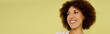 © Bliss - A joyful young Black woman with curly hair poses in her underwear against a bright yellow background.