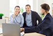 © Studio Romantic - Professional realtor, lawyer, financial advisor consulting happy family couple clients in office, interested customers meeting broker bank worker, discussing agreement, showing on laptop online