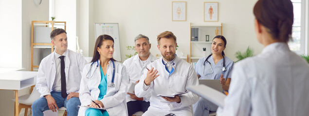 group of professional doctors sitting on meeting discussing patient diagnosis and treatment in clini