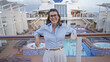 © Krakenimages.com - Woman enjoying a tropical drink on a cruise ship outdoors characterized by sunny weather and relaxation, emphasizing confidence and joy in travel and leisure settings.