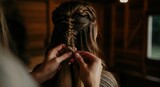 Woman braiding hair in cozy wooden cabin