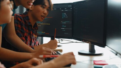 Slow motion back end software developer engineer for computer programming working together on debugging writing computing code, solving complex algorithms display on monitor in office. Burgeoning