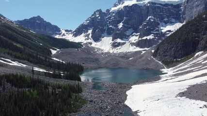 Poster - Drone footage of consolation lakes with snow covered hills