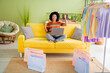© deagreez - Full body portrait of pretty young girl raise fist credit card laptop free time modern interior flat indoors