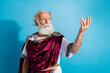 © deagreez - Photo of attractive old man politician speech recipe poem dressed greek god emperor actor costume isolated on blue color background