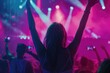 © darshika - Happy people dancing and listening to DJ at nightclub concert.
