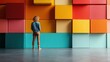 A woman stands facing a wall with large, colorful, geometric cubes creating a vibrant and modern art piece, evoking creativity and contrasting styles of calm and boldness.