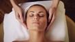 © Archil - A young woman enjoys a relaxing facial massage, embodying serenity and self-care amid a tranquil spa setting for rejuvenation.