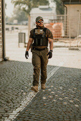 Wall Mural - Soldier walking on cobblestone street wearing tactical gear