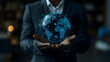 © HQAsset - Digital Globe: Businessman Carefully Holds a Futuristic Holographic Earth, Representing Global Network Connectivity and Data Flow, in a Dark Setting.