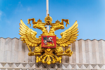 Wall Mural - Double golden eagle. Coat of arms of Russia on the roof top of the Big Kremlin concert hall