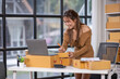 © David - Startup girl Small SME business owners work with laptop computers at work. with parcel paper boxes for delivery to customers online selling, Ecommerce,