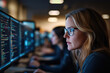 ©  Visual Pioneer - Focused woman coding on computer screens in tech environment