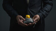 © Mutshino_Artwork - Businessman Holding Piggy Bank in Dark Room Symbolizing Financial Protection and Savings