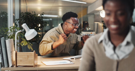Fototapete - Excited, black man or night with celebration for winning, promotion or offer at office desk. Happy African, male person or winner with smile on computer for victory, good news or success at workplace