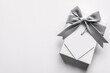 © thoriq - Elegant White Gift Box with Grey Ribbon