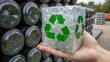 © Pixteegraph - Recycle to save wildlife. A hand holds a clear cube filled with recyclable materials, featuring a green recycling symbol, set against a backdrop of stacked containers.
