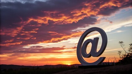 Wall Mural - Elegant Silhouette of a White Email Logo Against a Sunset Background, Symbolizing Communication and Digital Connection for Business and Personal Use