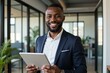 © SimpleDesignStudio - Professional Businessman Holding Tablet in Modern Office Setting, Perfect for Business Marketing and Corporate Branding Materials