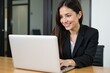 © NeedMoreMars - Professional Woman Working on Laptop in Office Setting, Ideal for Business and Technology Websites, Marketing Materials, and Corporate Branding